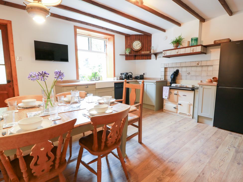 A kitchen with a dining table and chairs at Balsaggart Farm