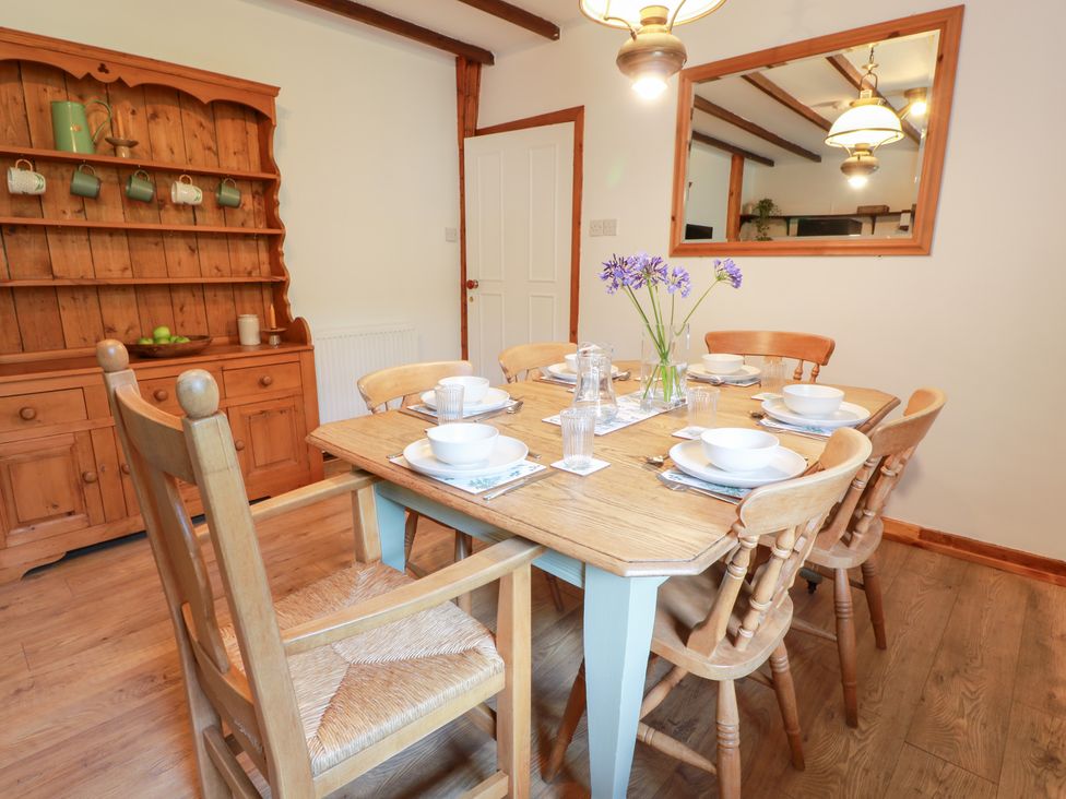 A dining room with a table set for a meal at Balsaggart Farm