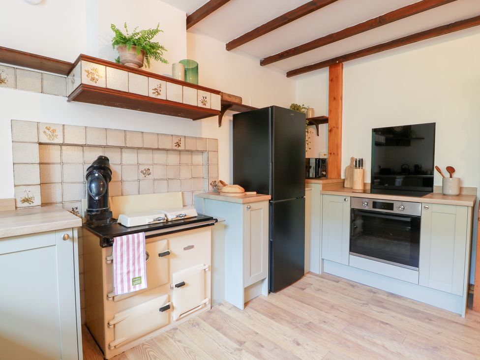 A kitchen with stove, refrigerator and oven at Balsaggart Farm