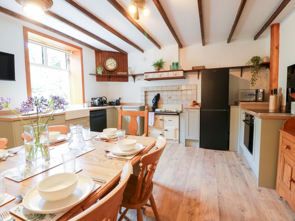 A kitchen with dining table and appliances at Balsaggart Farm