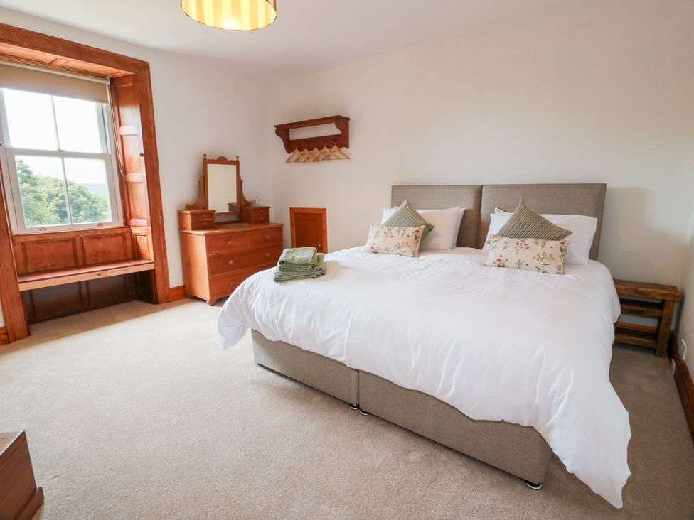 A bedroom with a double bed and window at Balsaggart Farm