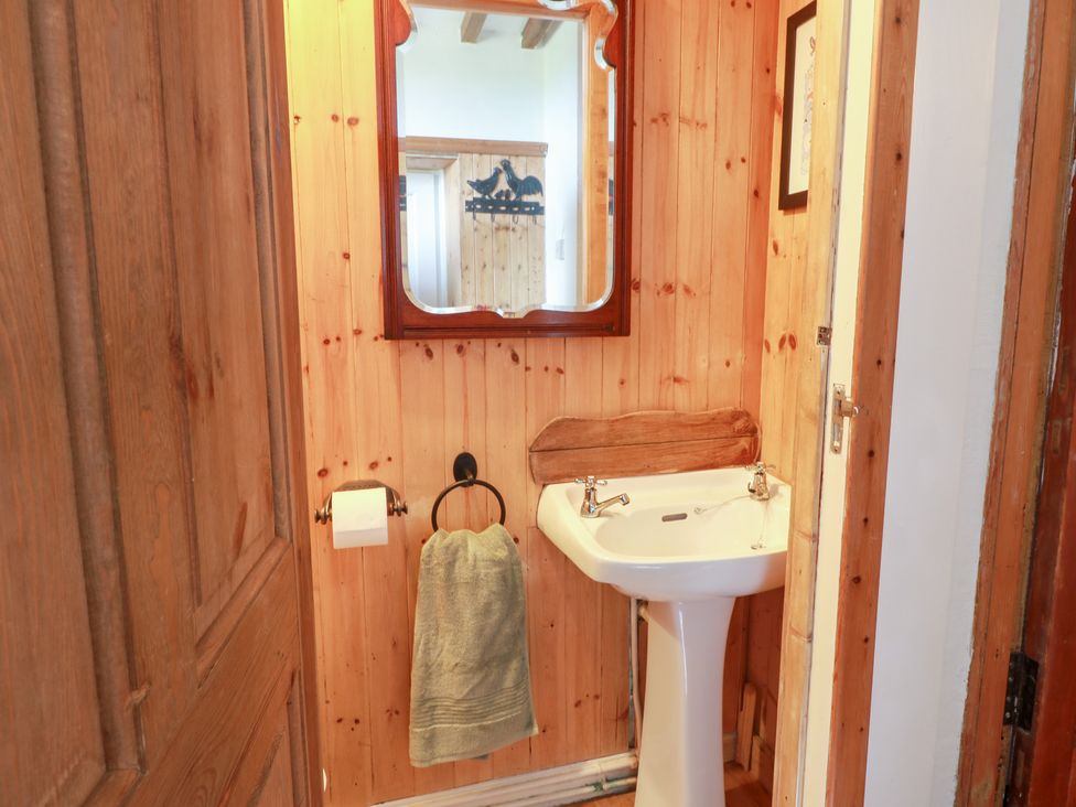 A bathroom with a sink and mirror at Balsaggart Farm