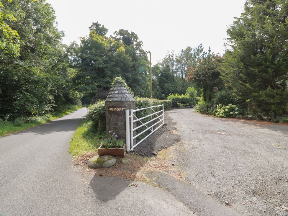 A pathway with a gate and sign at Balsaggart Farm