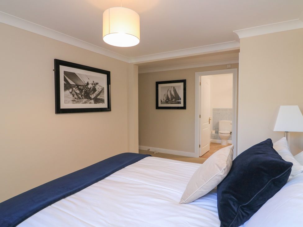 A bedroom with a bed and wall art at 6 Dartmouth House in Dartmouth