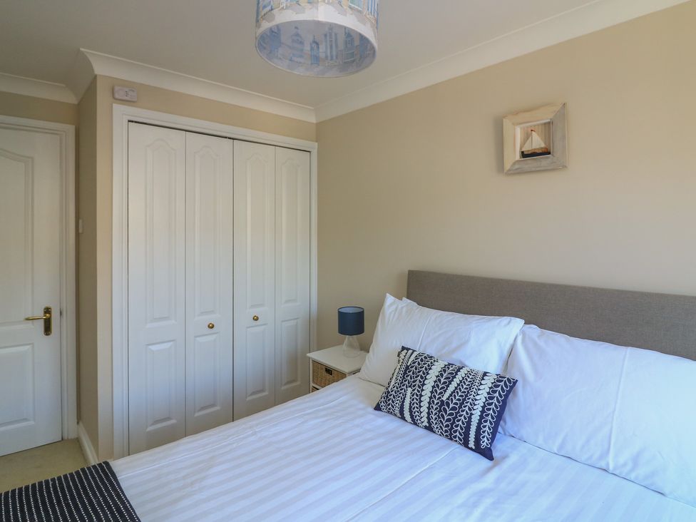 A bedroom with a bed and wardrobe at 6 Dartmouth House in Dartmouth