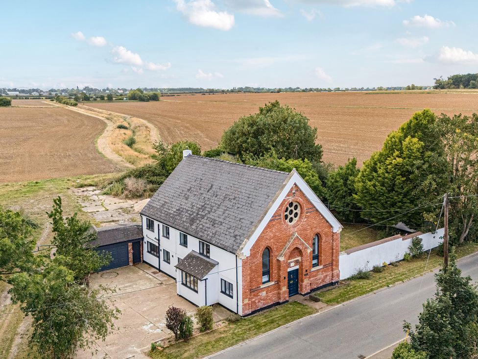 A building with surrounding fields and trees at The Old Chapel in Glentworth near Ingham