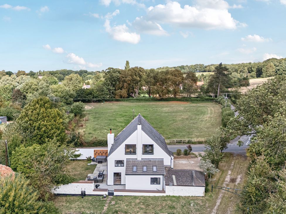 An aerial view of a house with a field and trees at The Old Chapel in Glentworth near Ingham