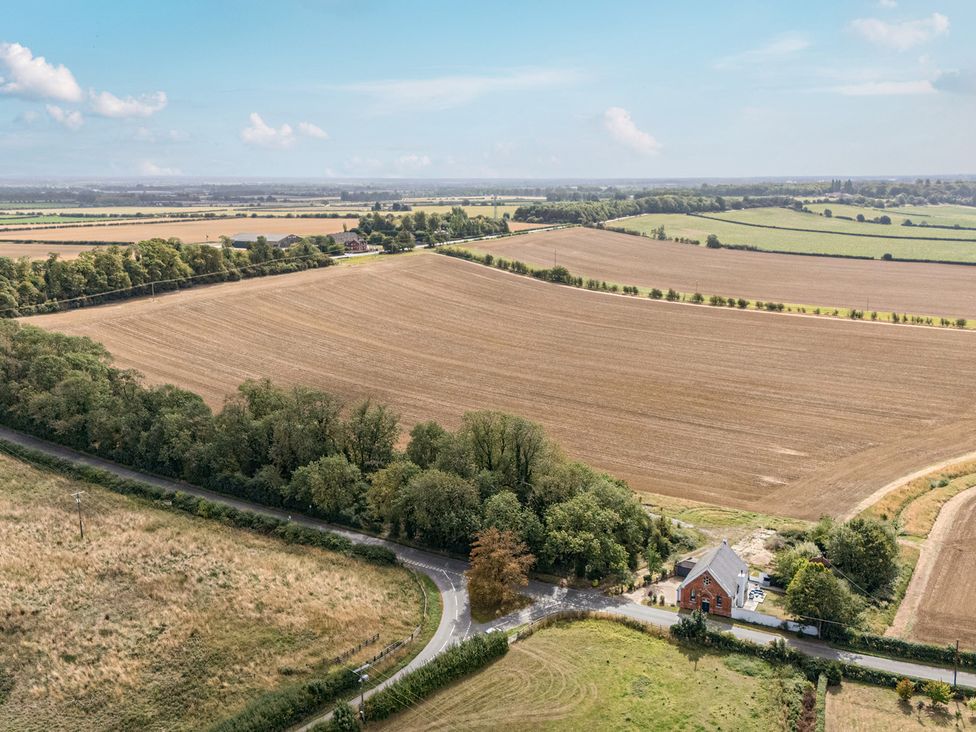 A view of fields and a road with a house at The Old Chapel in Glentworth near Ingham