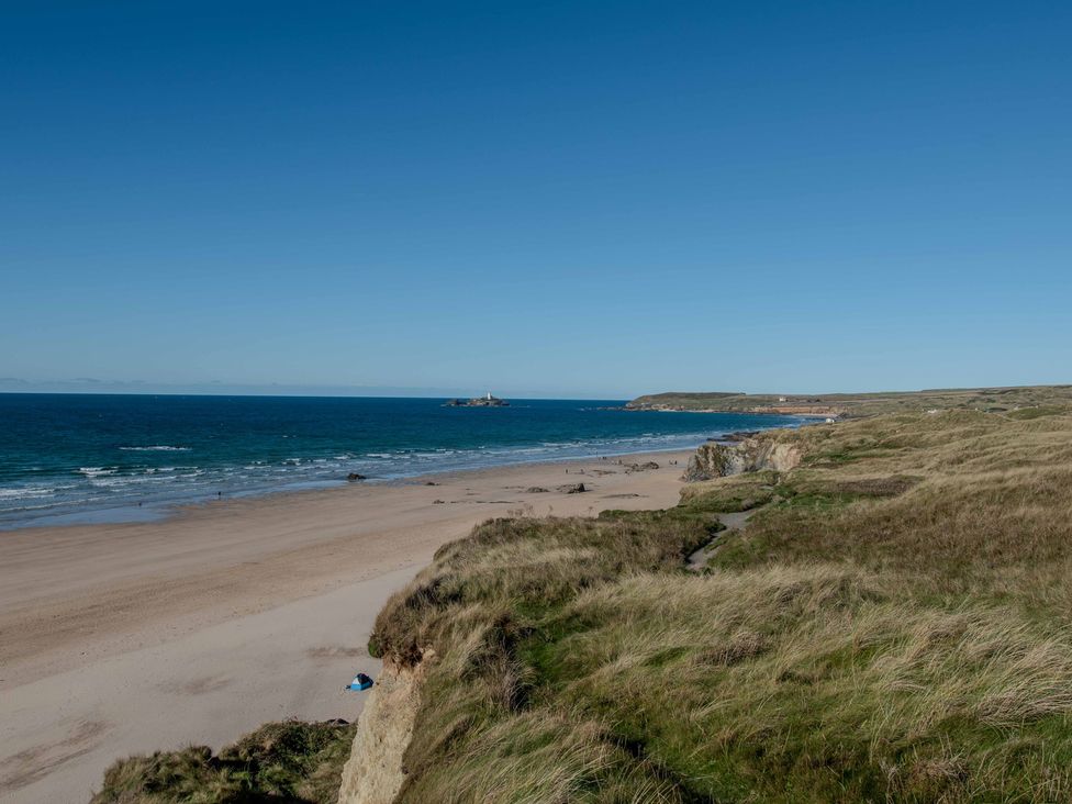 A beach with cliffs and ocean at Chalet 3 Wipeout in Hayle