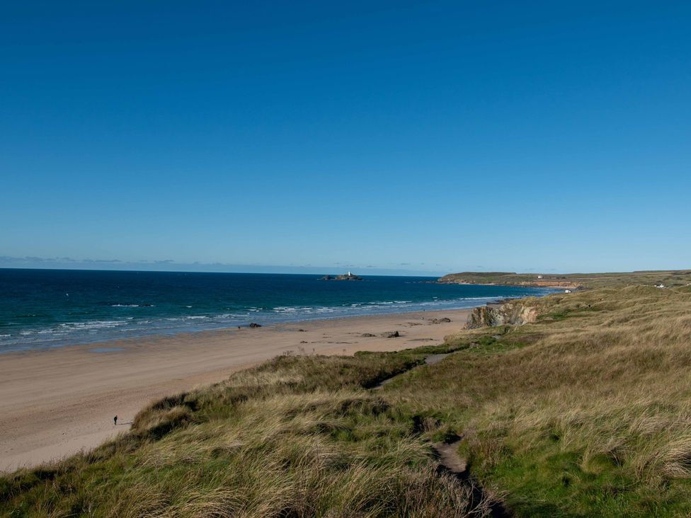 A beach with sand and grass in Hayle