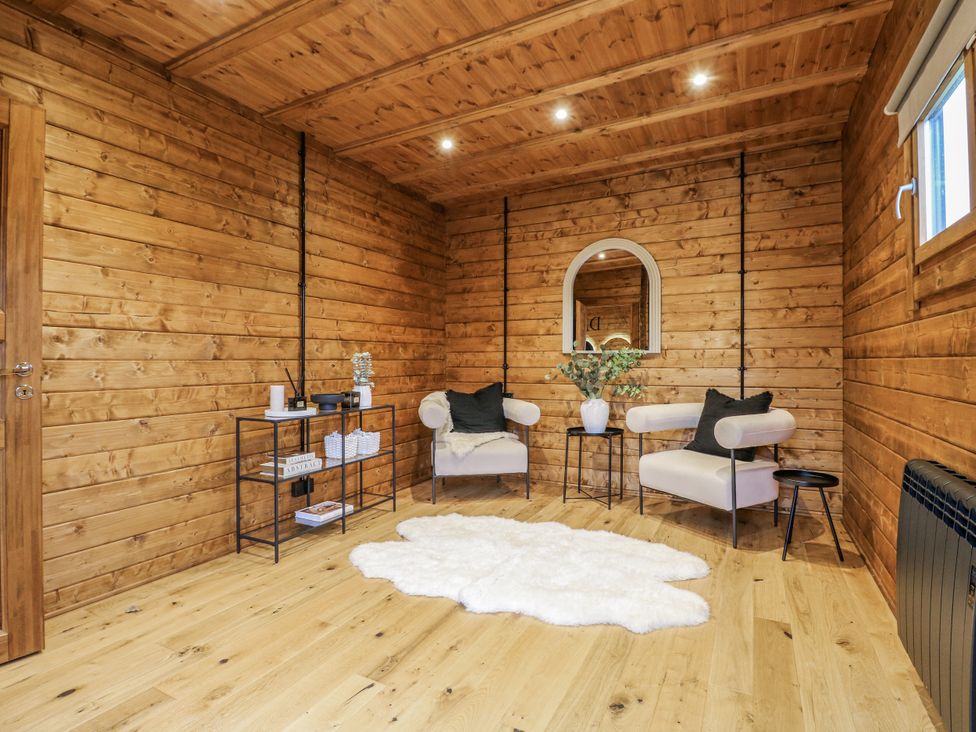 A snug with wooden walls and two chairs at Bee Hive South Luffenham near Edith Weston