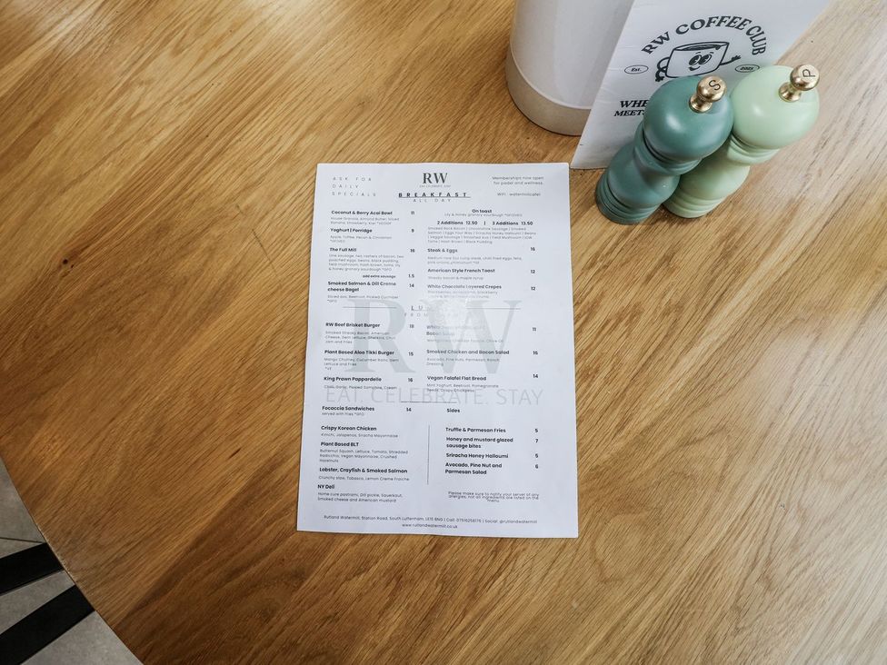 A breakfast menu on a wooden table at Badger's Burrow in Edith Weston