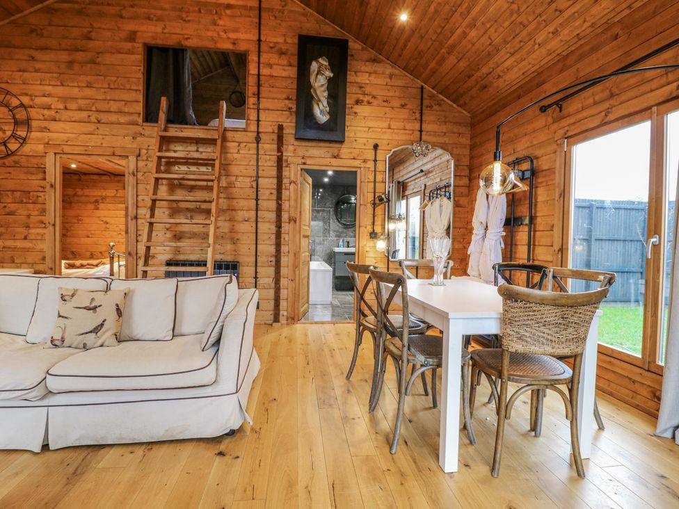 A living room with a sofa and dining area at Rabbit Hole near Stamford