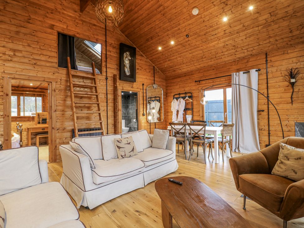 A living room with a sofa and dining table at Rabbit Hole near Stamford