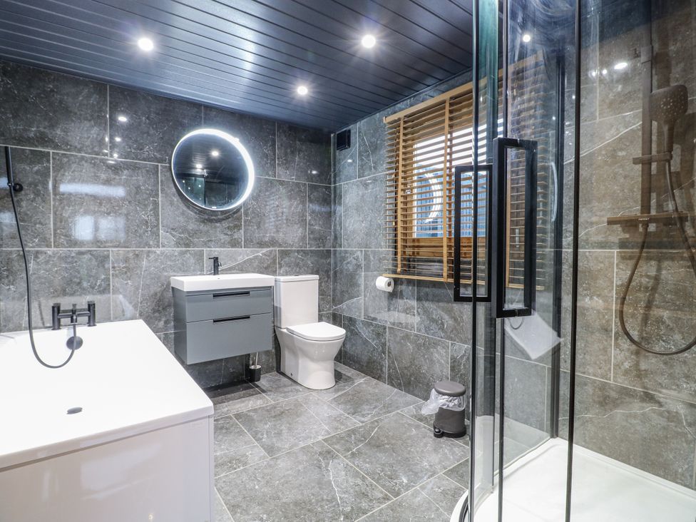 A bathroom with a bathtub, toilet, sink, and shower at Rabbit Hole near Stamford