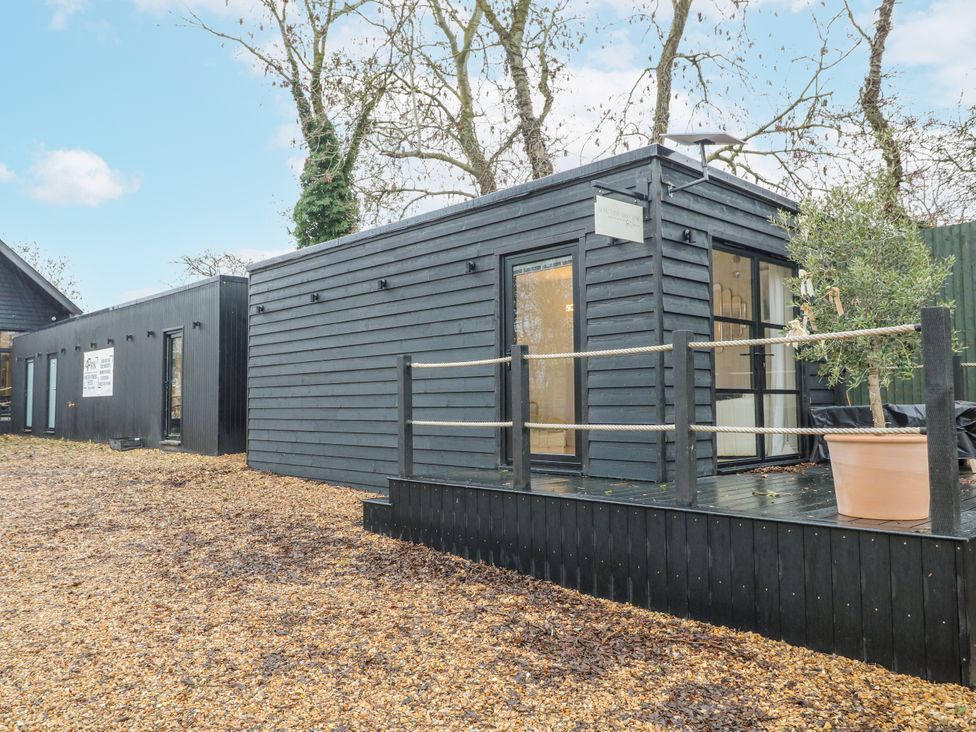 A modern building with a deck and railing at Rabbit Hole near Stamford