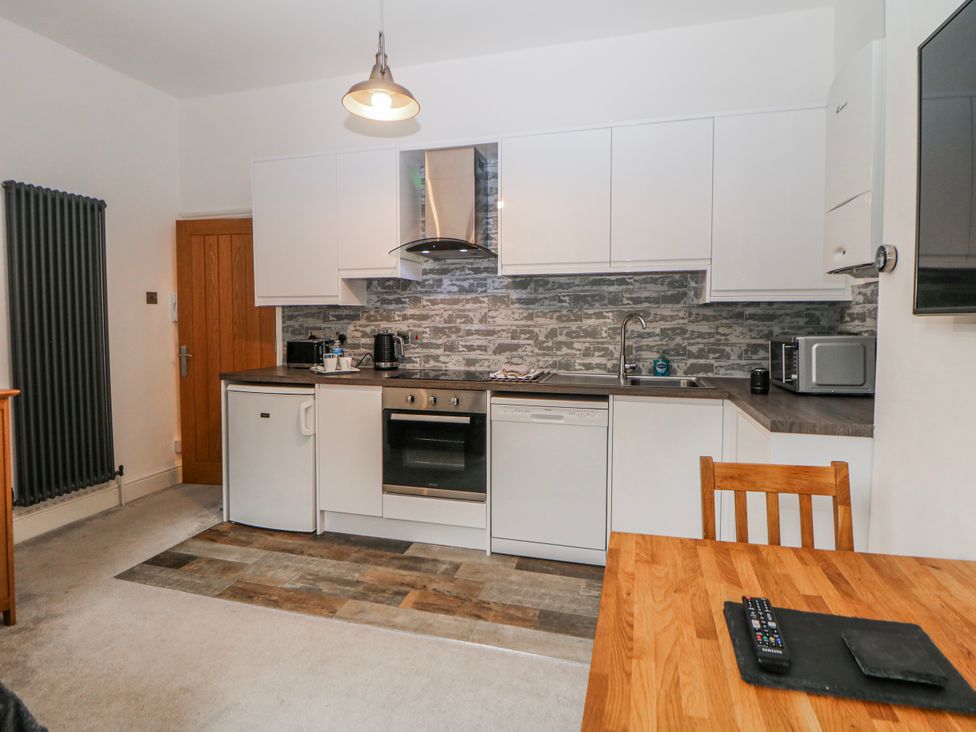 A kitchen with appliances and dining table at Masson (78) in Matlock