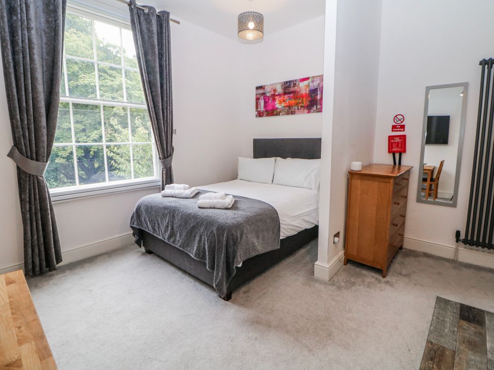 A bedroom with a bed and window at Masson (78) Matlock