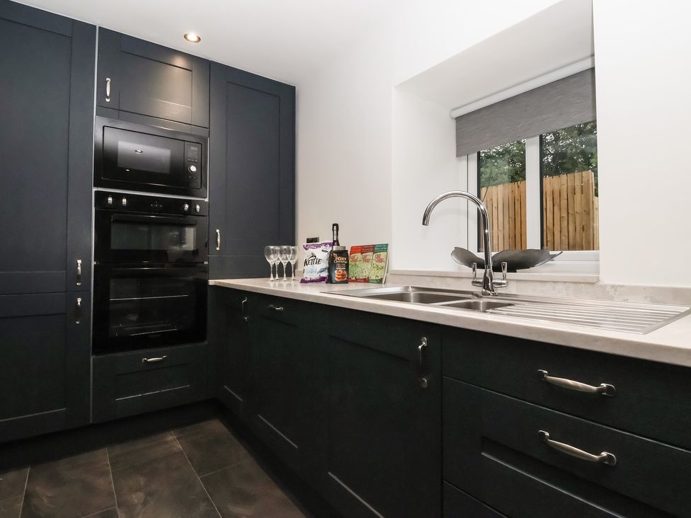 A kitchen with appliances and a sink at Virginia Cottage in Skipton