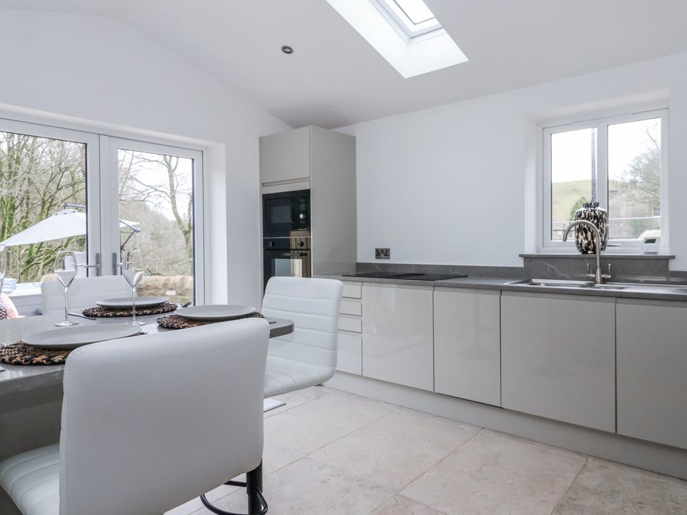 A kitchen with a table and chairs at Beckside in Skipton