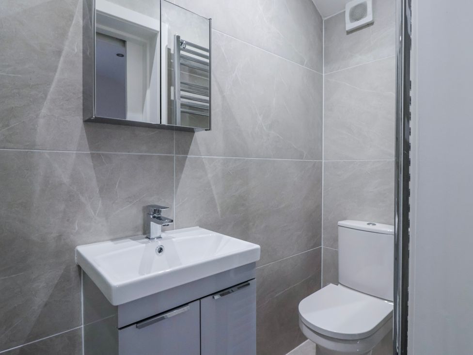 A bathroom with a sink and toilet at Beckside in Skipton