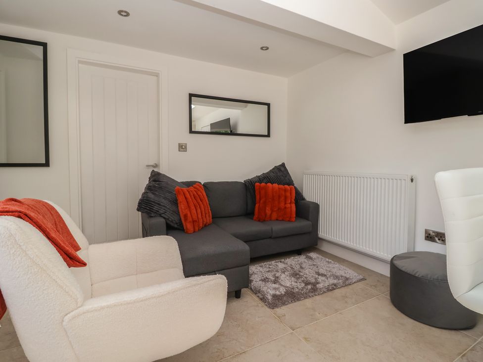 A living room with a sofa and armchair at John's Lodge in Winterburn