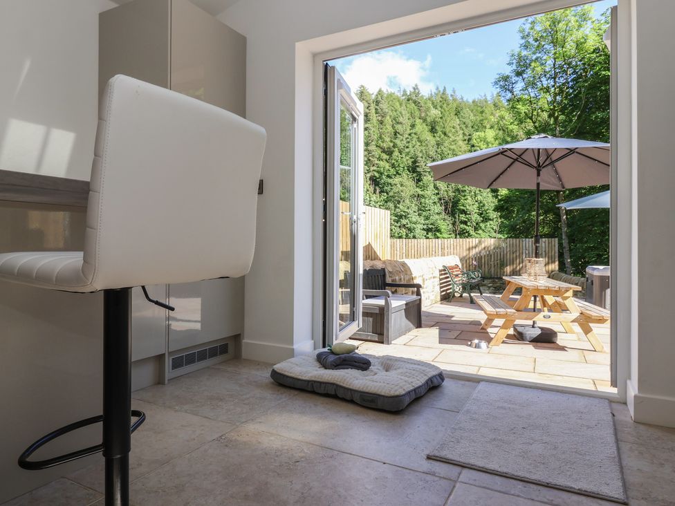 A kitchen with a counter and door to patio at John's Lodge in Winterburn
