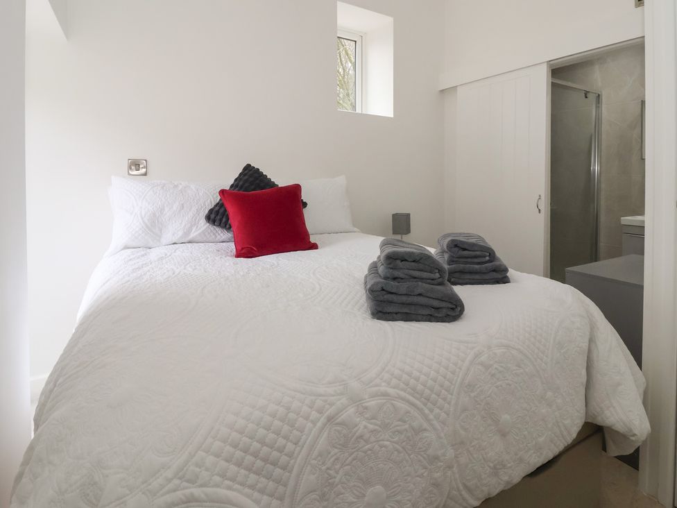 A bedroom with a bed and bathroom visible at John's Lodge in Winterburn