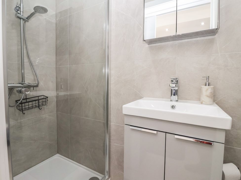 A bathroom with a shower and sink at John's Lodge, Winterburn