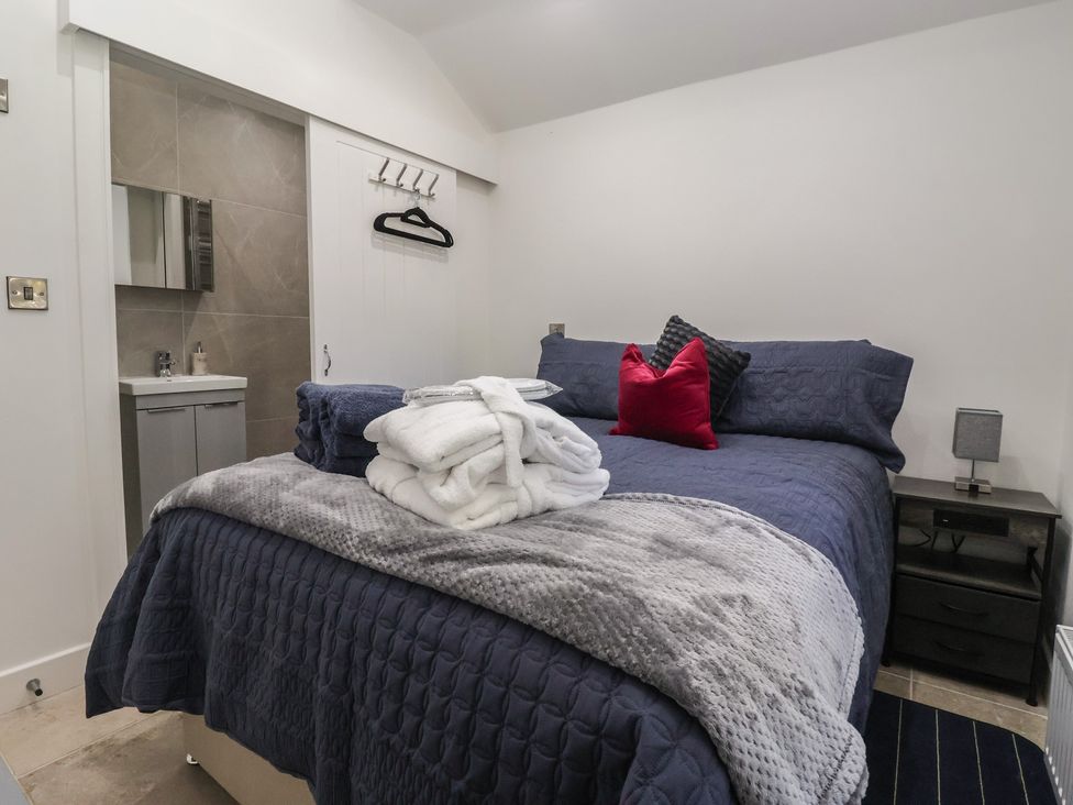 A bedroom with a bed and a sink at John's Lodge in Winterburn