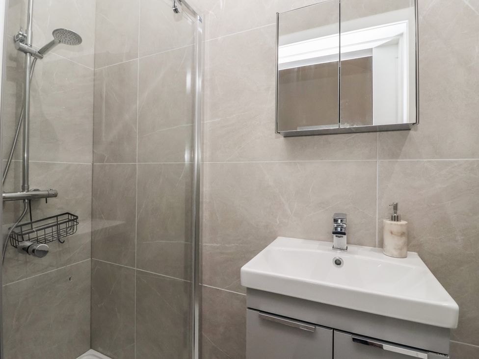 A bathroom with a shower and sink at John's Lodge Winterburn