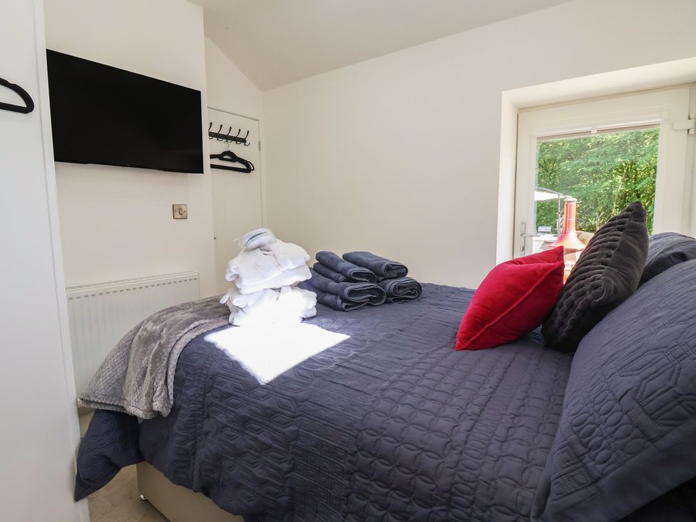 A bedroom with a bed and towels at John's Lodge in Winterburn