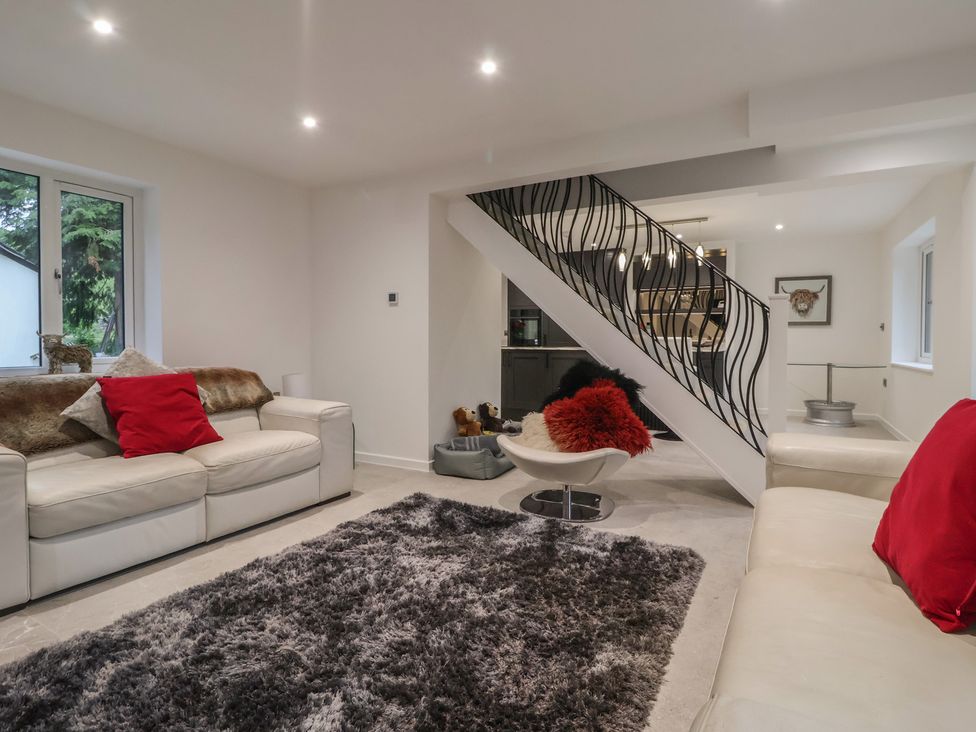 A living room with a sofa and rug at Wood Cottage in Skipton