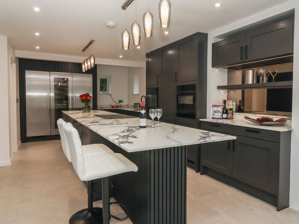 A kitchen with a marble island and modern appliances at Wood Cottage in Skipton