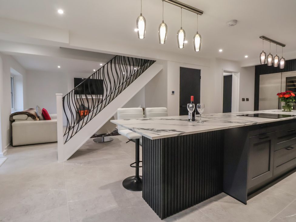 A kitchen with a staircase and seating area at Wood Cottage in Skipton