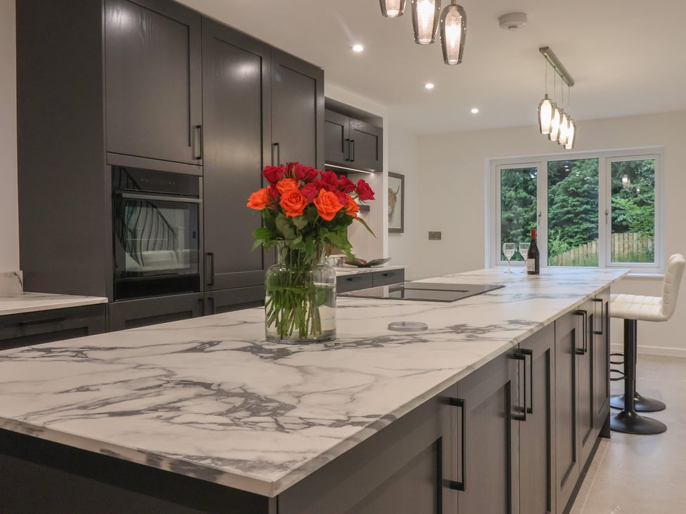 A kitchen with cabinets and a countertop at Wood Cottage in Skipton