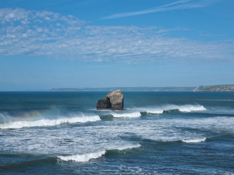 A rocky outcrop in the ocean with waves at Sea View Beach Apartment in Thurlestone