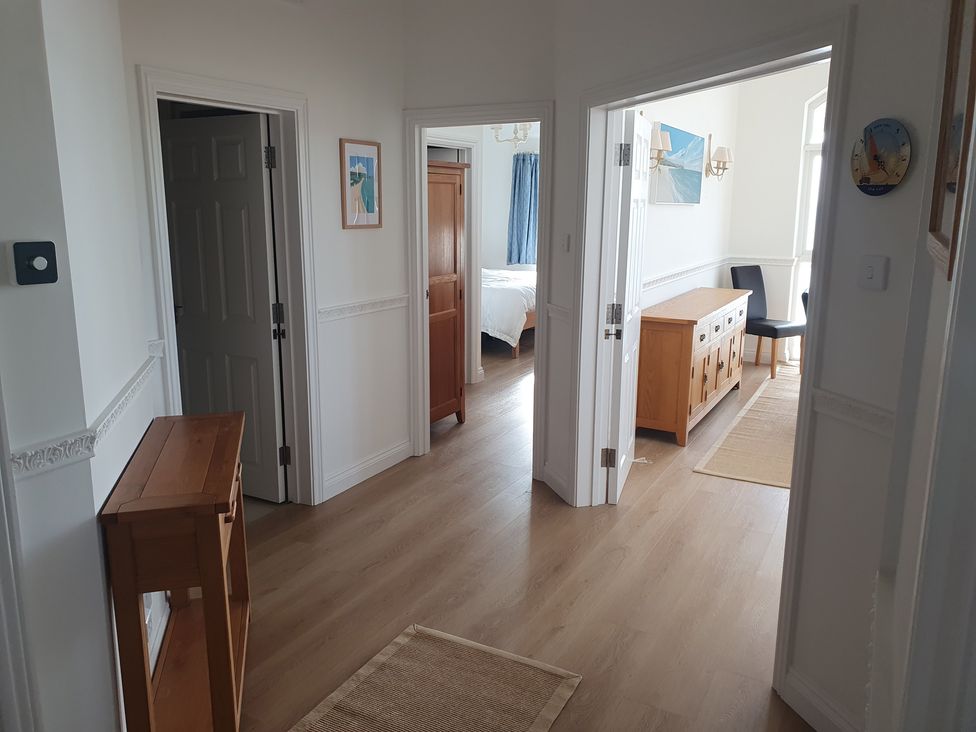 A hallway with doors and furniture at Sea View Beach Apartment in Thurlestone