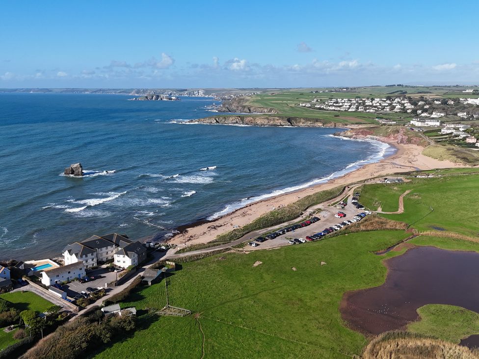 An aerial view of a beach and cars parked near Sea View Beach Apartment Thurlestone