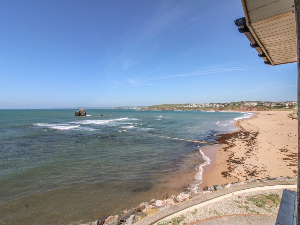 A beach with sand and seaweed at Seaview Beach Apartment, 11 Thurlestone Rock, Thurlestone