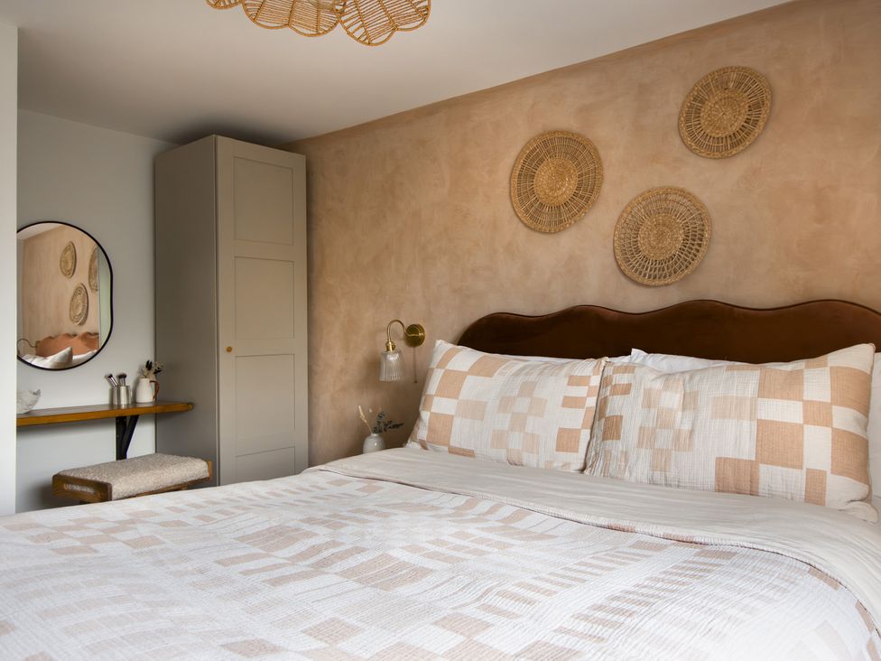 A bedroom with a bed and wardrobe at Rock View in Trethurgy near St Austell