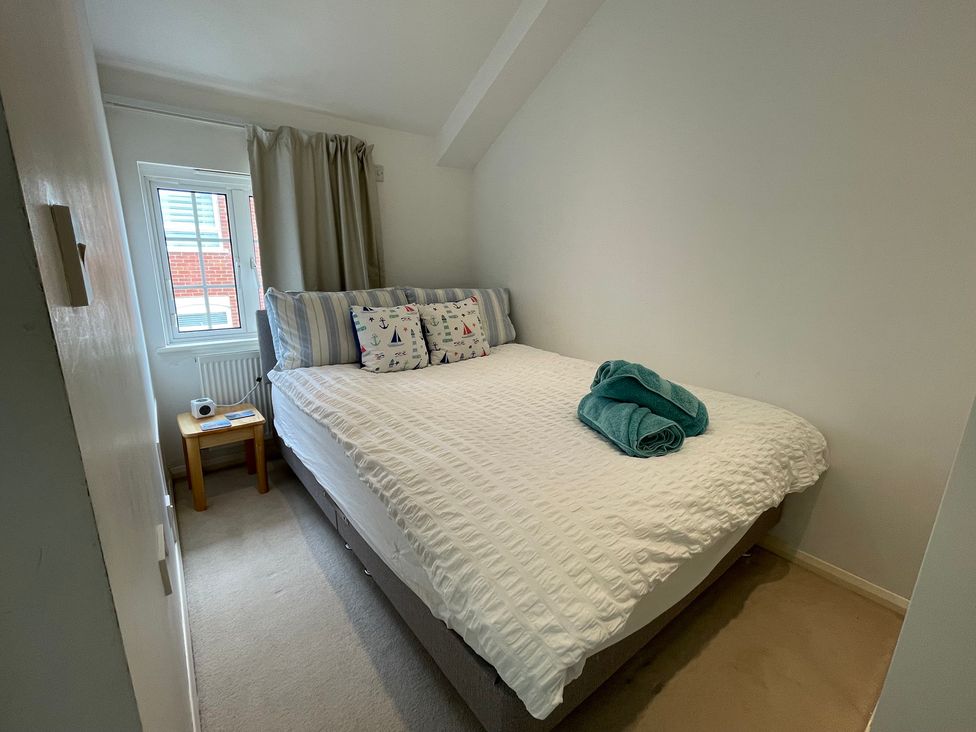A bedroom with a bed and bedside table at 23 Millhams Street in Christchurch