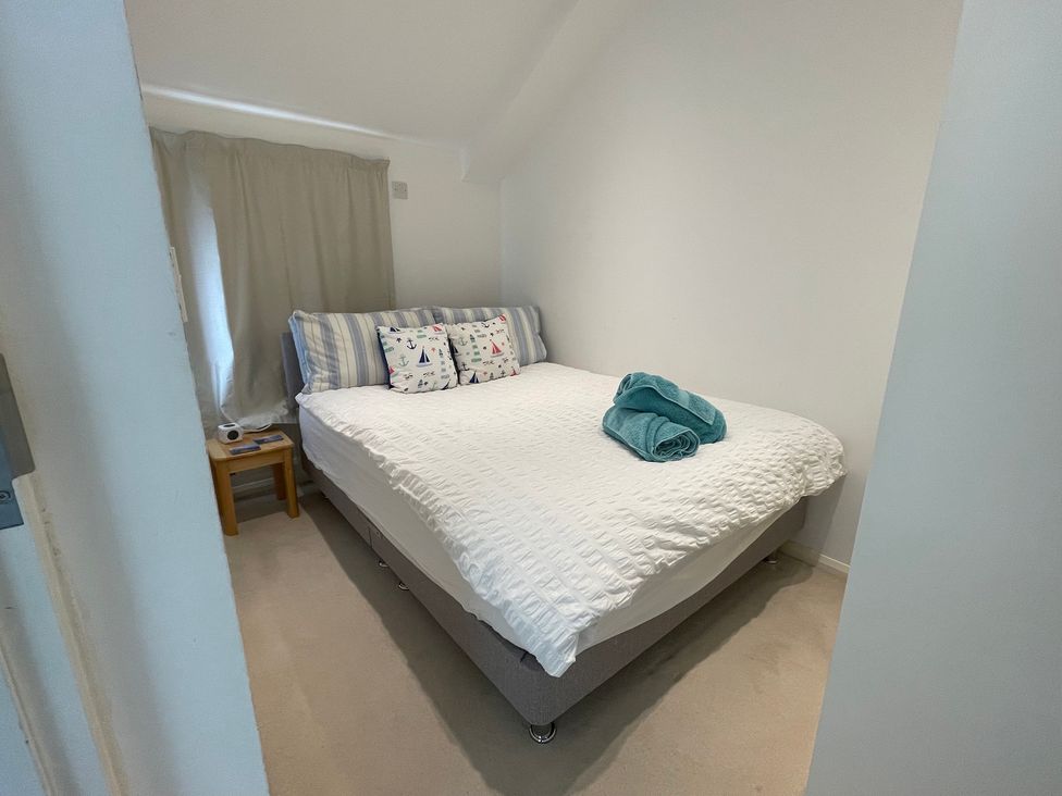 A bedroom with a bed and side table at 23 Millhams Street in Christchurch
