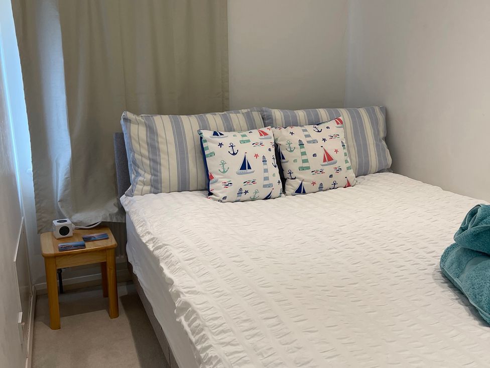 A bedroom with a bed and decorative pillows at 23 Millhams Street Christchurch