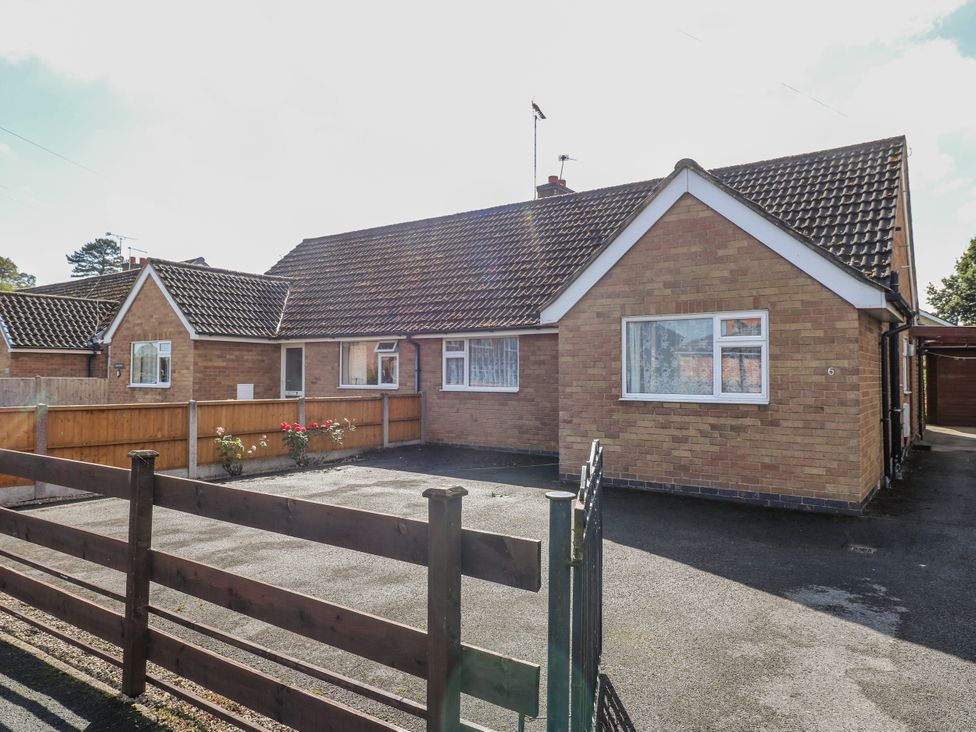 A bungalow exterior with a fence and driveway at 6 Pine Walk in Uttoxeter