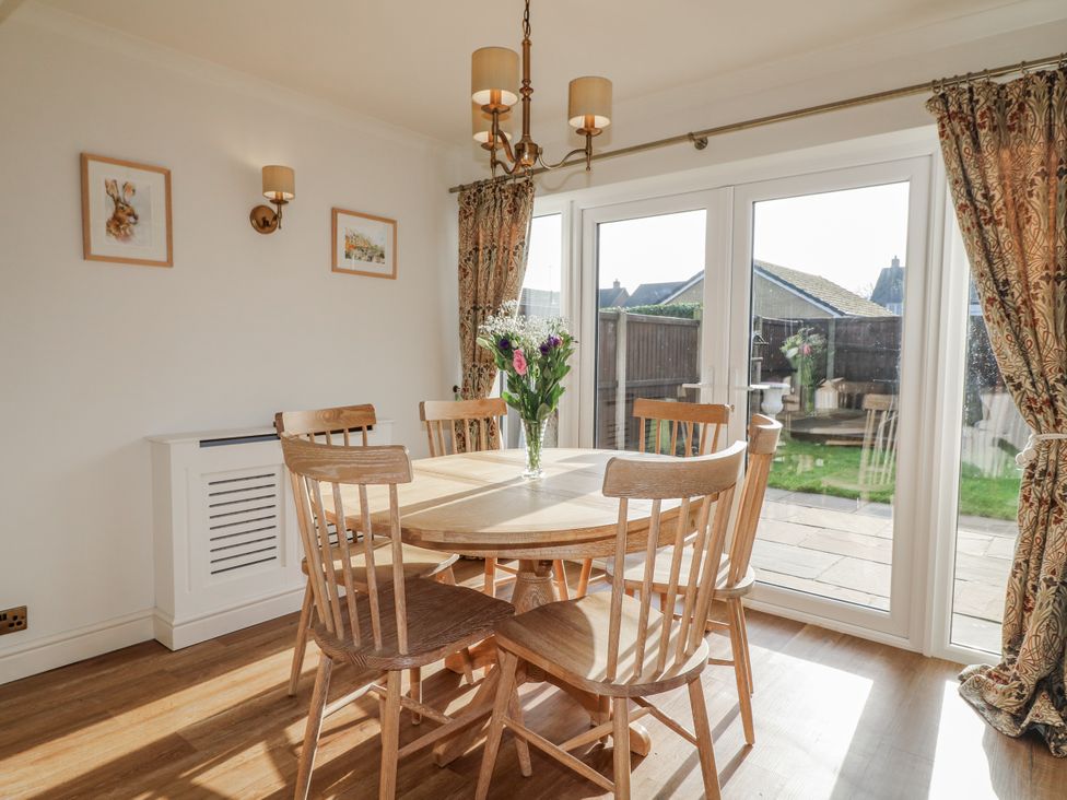 A dining room with a round table and chairs at 6 Pine Walk in Uttoxeter