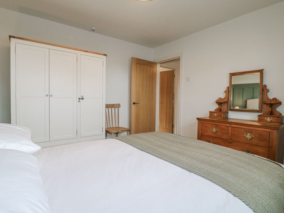 A bedroom with a bed and a dresser at 6 Pine Walk in Uttoxeter