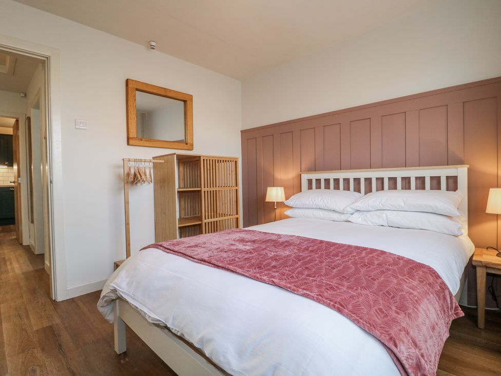 A bedroom with a bed and a bookshelf at 6 Pine Walk in Uttoxeter