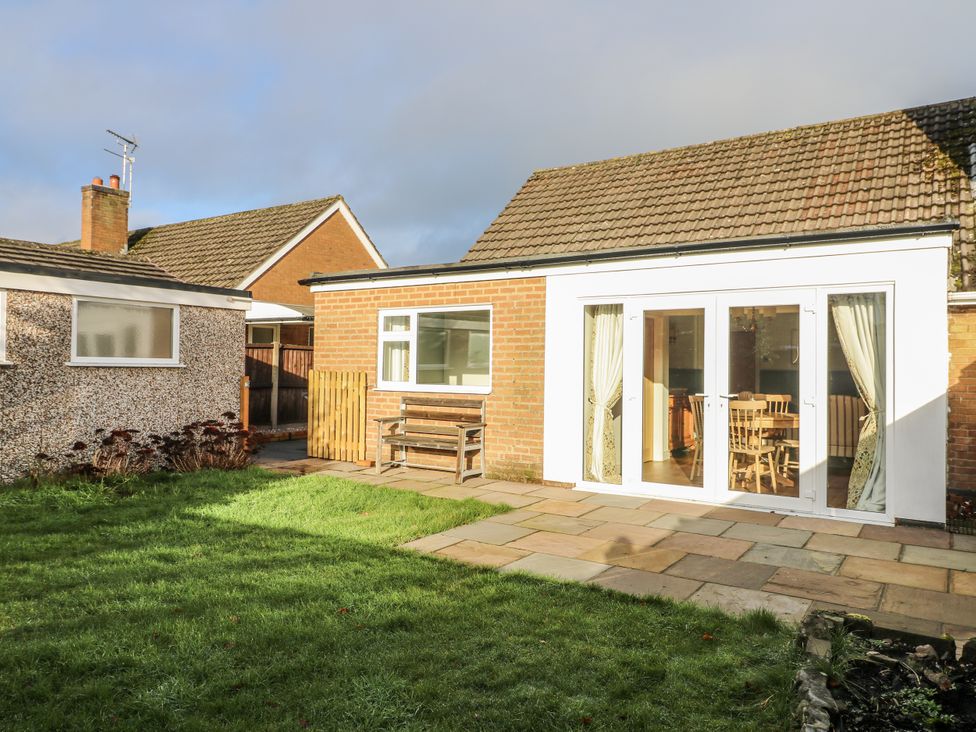 A house with a garden and patio area at 6 Pine Walk Uttoxeter