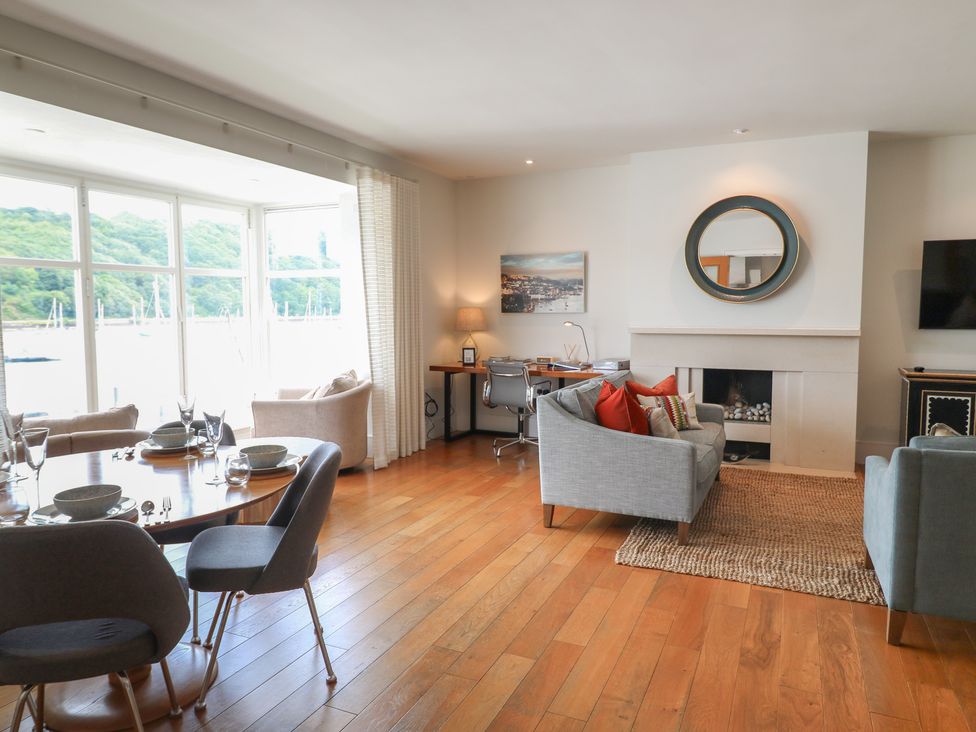 A living room with a table and chairs at 22 Dart Marina in Dartmouth